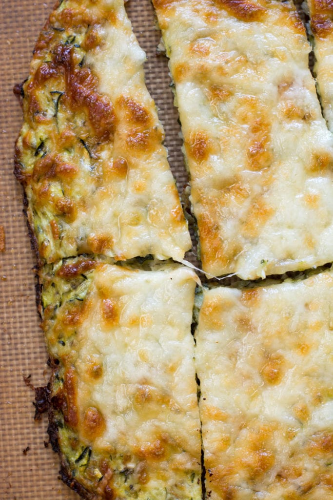 Try these Keto Cheesy Zucchini Breadsticks for a low carb appetizer or light lunch! At just 1.9 net carbs per breadstick this is a great low carb game day snack! #keto