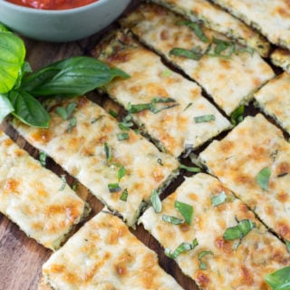 Try these Keto Cheesy Zucchini Breadsticks for a low carb appetizer or light lunch! At just 1.9 net carbs per breadstick this is a great low carb game day snack! #keto