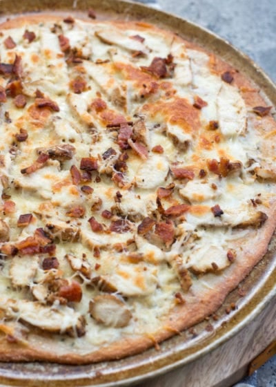 This homemade Chicken Bacon Ranch Pizza is loaded with grilled chicken, crispy bacon, a creamy ranch pizza sauce, and a perfectly crispy low carb crust! Only 3 net carbs per slice!