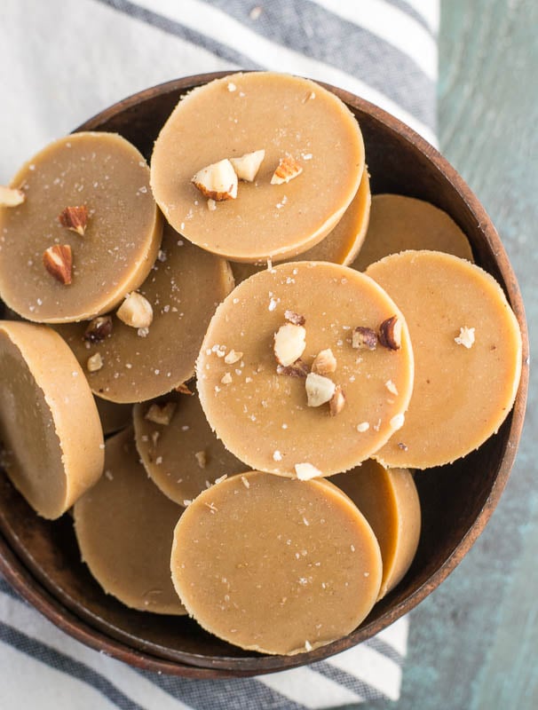 Overhead view of pieces of keto peanut butter fudge piled in a wooden bowl. 