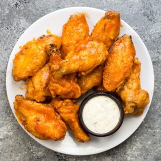 These Keto Buffalo Wings are ultra crispy with no breading then covered in a buttery, tangy buffalo sauce! Only 2 net carbs per serving! #keto
