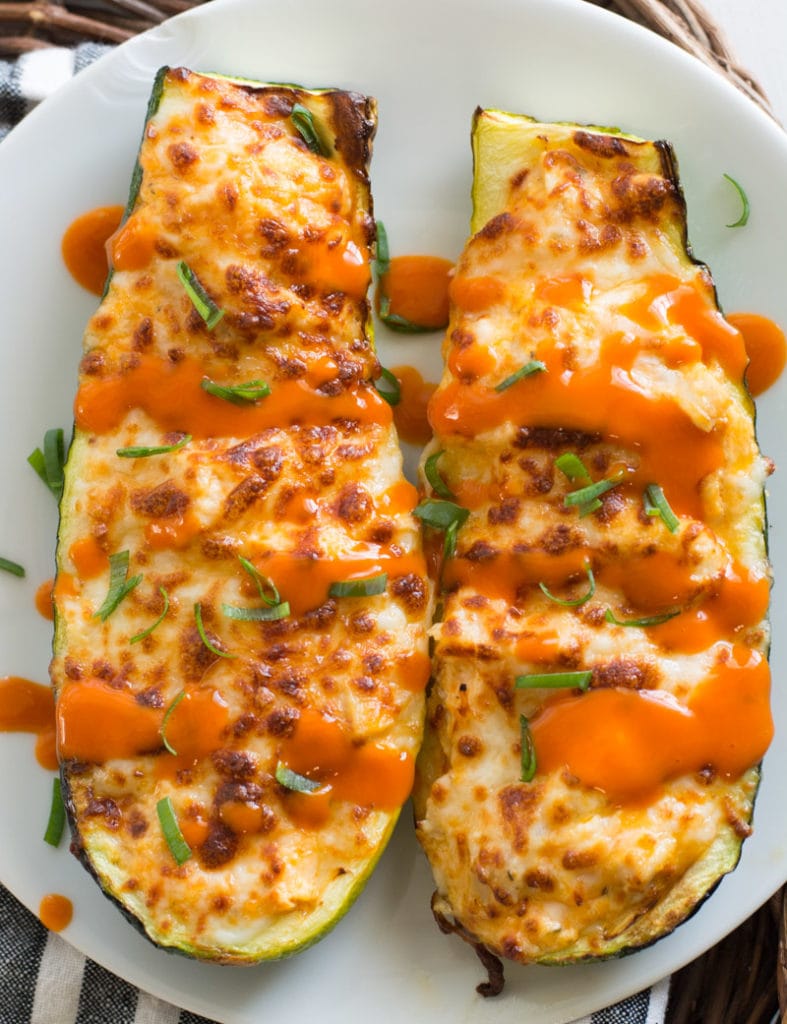 These easy Buffalo Chicken Zucchini Boats are loaded with chicken, cheese and spicy buffalo sauce! At only 4 net carbs per serving this will be your new favorite keto dinner!