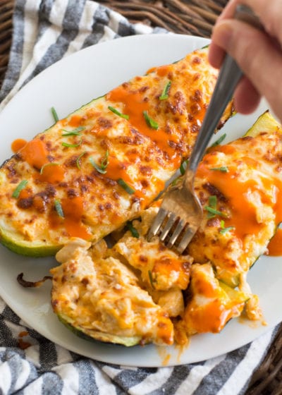 These easy Buffalo Chicken Zucchini Boats are loaded with chicken, cheese and spicy buffalo sauce! At only 4 net carbs per serving this will be your new favorite keto dinner!