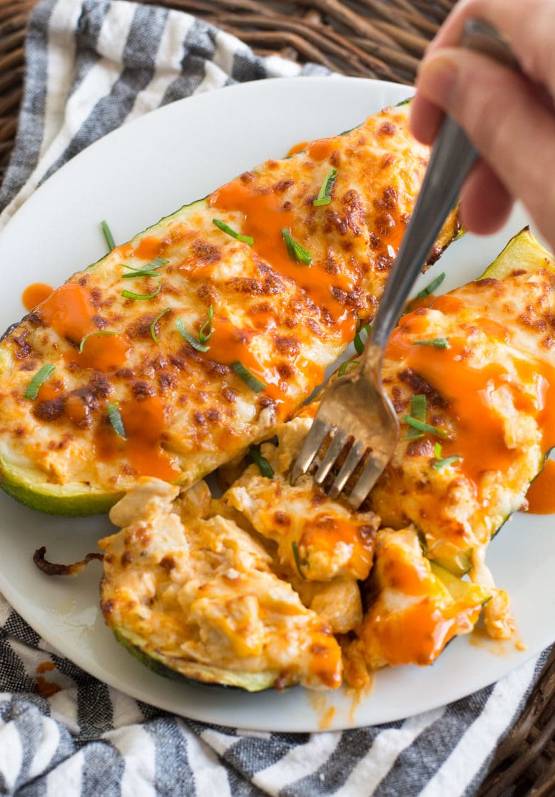 These easy Buffalo Chicken Zucchini Boats are loaded with chicken, cheese and spicy buffalo sauce! At only 4 net carbs per serving this will be your new favorite keto dinner!