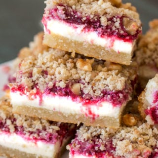 These delicious Keto Cranberry Cheesecake Bars have rich layers including an almond flour shortbread cookie crust, vanilla cheesecake, low carb cranberry sauce and a pecan crumble. At 5 net carbs each this is a decadent keto treat!