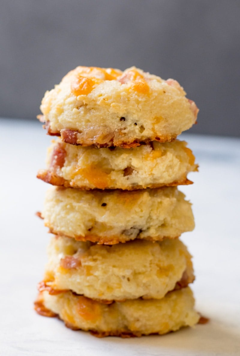 stacked ham and cheese biscuits on a gray countertop