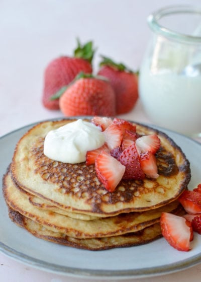 These Keto Strawberry Cream Cheese Pancakes are topped with a sweet vanilla cream cheese glaze! This easy keto breakfast recipe is about 2 net carbs per pancake and loaded with strawberry vanilla flavor!