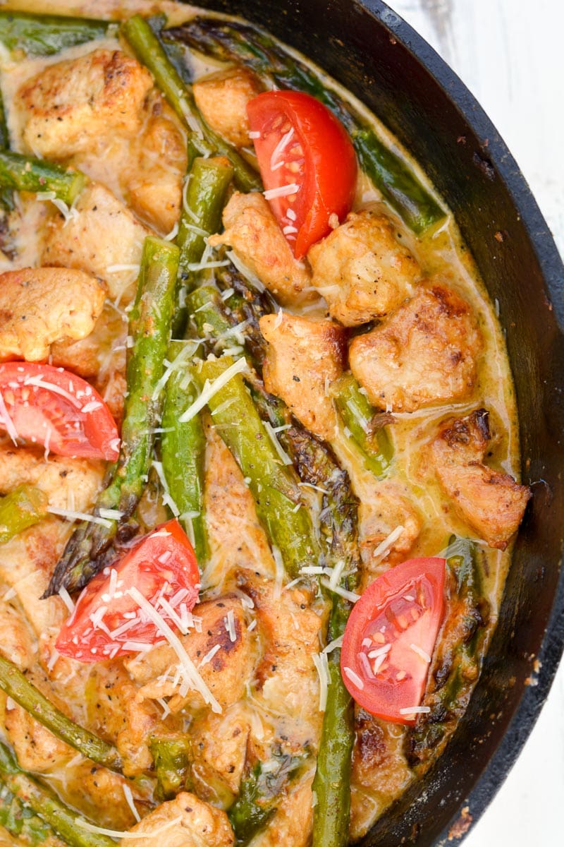 Keto Tuscan Chicken with Asparagus is an easy one pan low carb meal! Packed with seasoned chicken, tender asparagus and a rich parmesan cream sauce this will be a new family favorite!