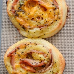 These Keto Ham and Cheese Rolls are smothered in a garlic poppy seed sauce you will love! These savory, low carb rolls come to just under 2 net carbs each!