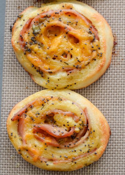 These Keto Ham and Cheese Rolls are smothered in a garlic poppy seed sauce you will love! These savory, low carb rolls come to just under 2 net carbs each!