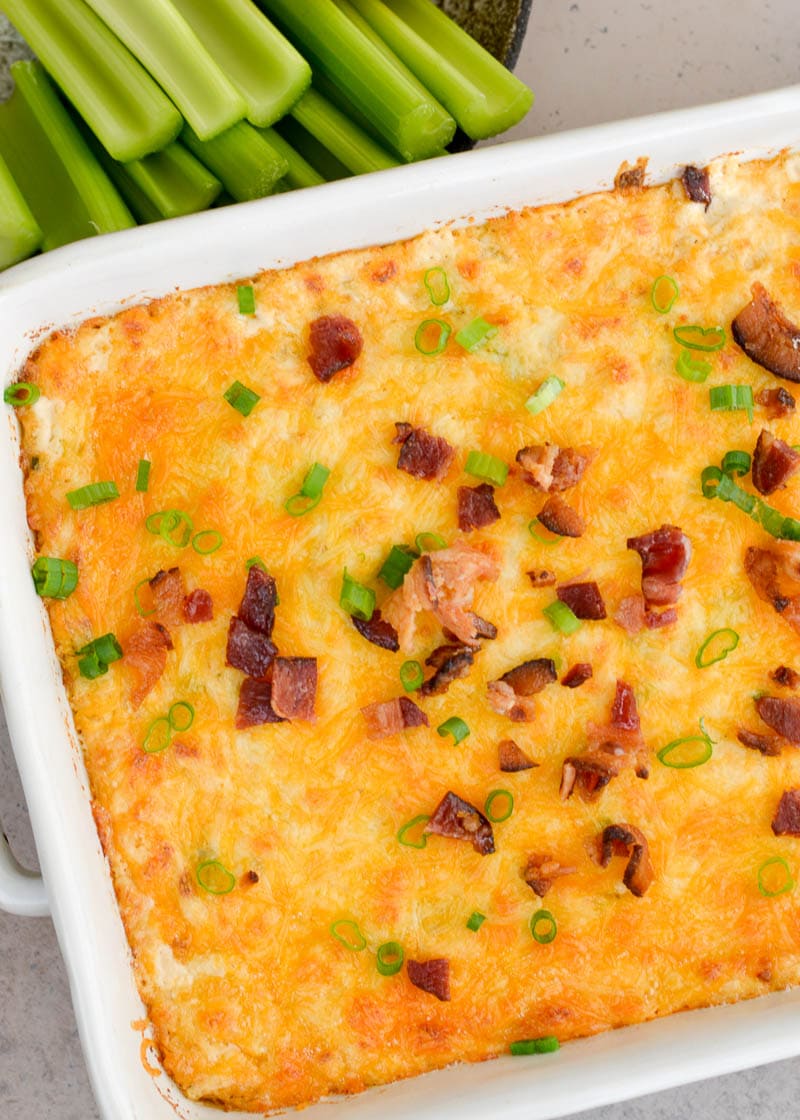 This Baked Crab Artichoke Dip is loaded with tender lump crab, crispy bacon, green onions, and three kinds of cheese! When paired with crunchy celery sticks this is the perfect low-carb game day appetizer! 