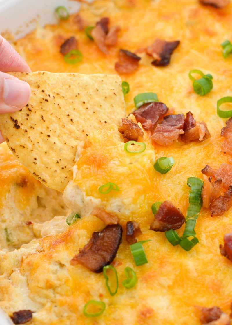 Hot Crab and Bacon Dip is the ultimate cheesy appetizer! Tender lump crab, crispy bacon, green onions and three kinds of cheese make this decadent dip a major crowd pleaser!