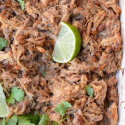 These delicious Instant Pot Carnitas are keto-friendly and easy to make! You can enjoy two street tacos served with a spicy keto slaw for fewer than 5 net carbs, making it the perfect low-carb dinner recipe!