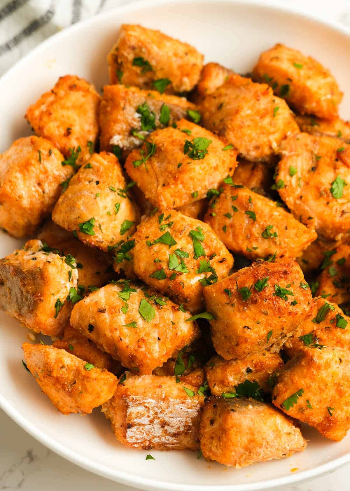 air fryer salmon bites on a white plate