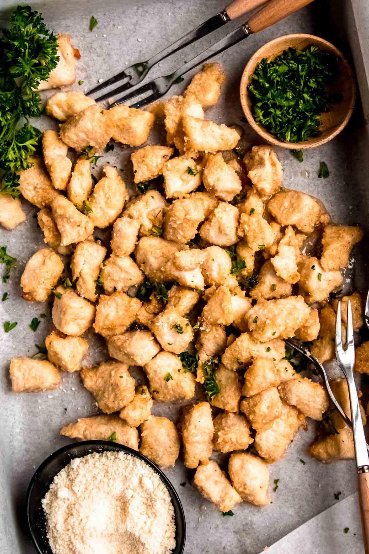 garlic parmesan chicken bites on a white table