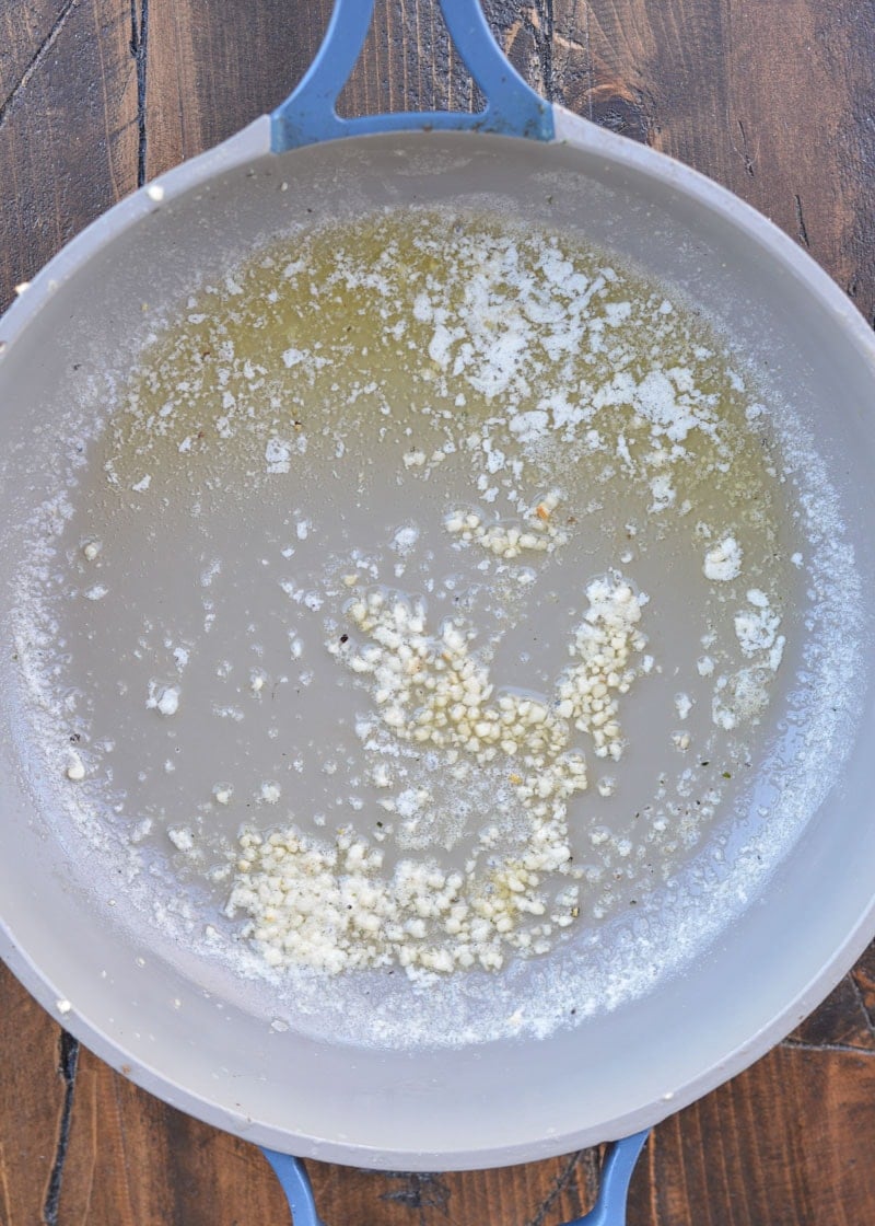 Start your Keto Shrimp Alfredo by sautéing your fresh garlic in a high-quality salted butter.