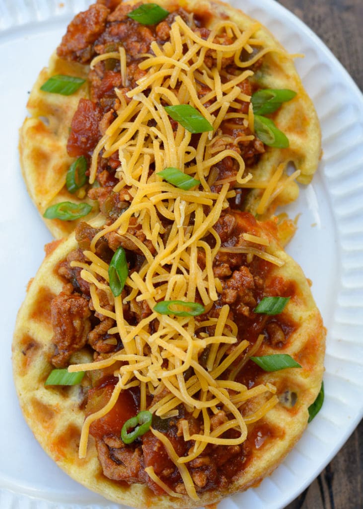 Top keto chaffles with chili and cheese for a warming, full keto dinner!