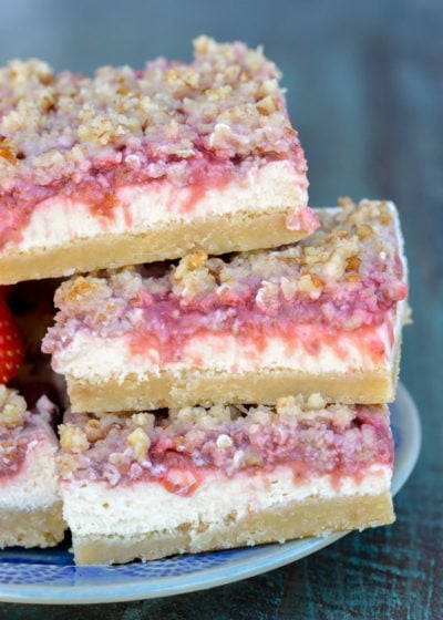 These Keto Strawberry Cheesecake Bars have a decadent buttery shortbread crust, delicious vanilla cheesecake with low carb strawberry sauce and are topped with a pecan crumble! Under 5 carbs each, these bars are going to become your go-to keto dessert!