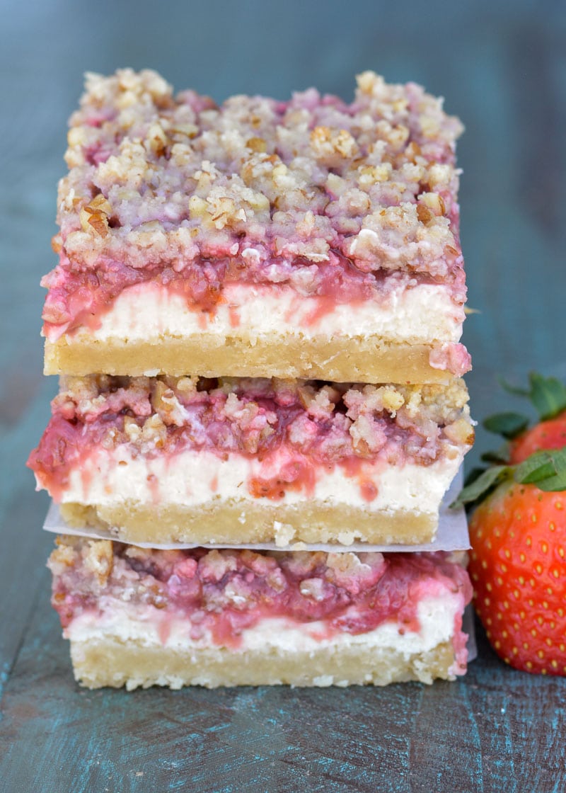 These Keto Strawberry Cheesecake Bars have a decadent buttery shortbread crust, delicious vanilla cheesecake with low carb strawberry sauce and are topped with a pecan crumble! Under 5 carbs each, these bars are going to become your go-to keto dessert!