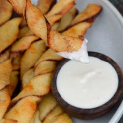 These easy Keto Cinnamon Twists have a delicious keto cream cheese dipping sauce for the best gluten free + keto snack! Enjoy two twists and frosting for about 3 net carbs.
