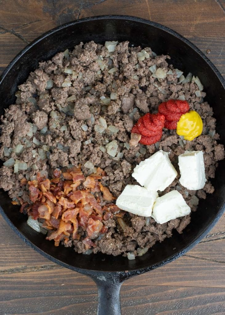 Ground beef and bacon in skillet