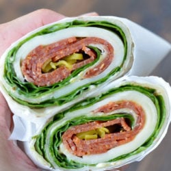 These Pepperoni Cheese Wraps are the perfect keto lunch! Deli pepperoni is paired with smoky provolone, fresh spinach and flavorful pesto aoili, all for about 5 net carbs!