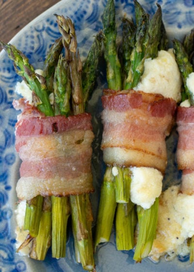 This Cheesy Bacon Wrapped Asparagus is the best keto side dish or appetizer! Enjoy 2 bundles of crispy bacon, tender asparagus, and a creamy parmesan filling for under 3 net carbs!