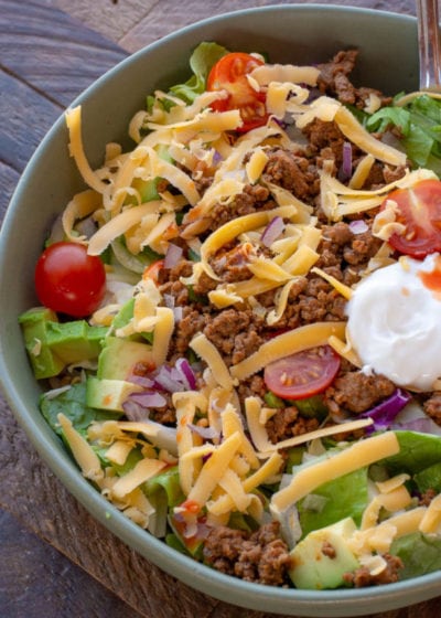 This easy Keto Taco Salad is easy, delicious, and healthy! Top your favorite greens with seasoned meat, tomato, avocado, peppers, and more for a lunch or dinner full of flavor and about 7 net carbs.