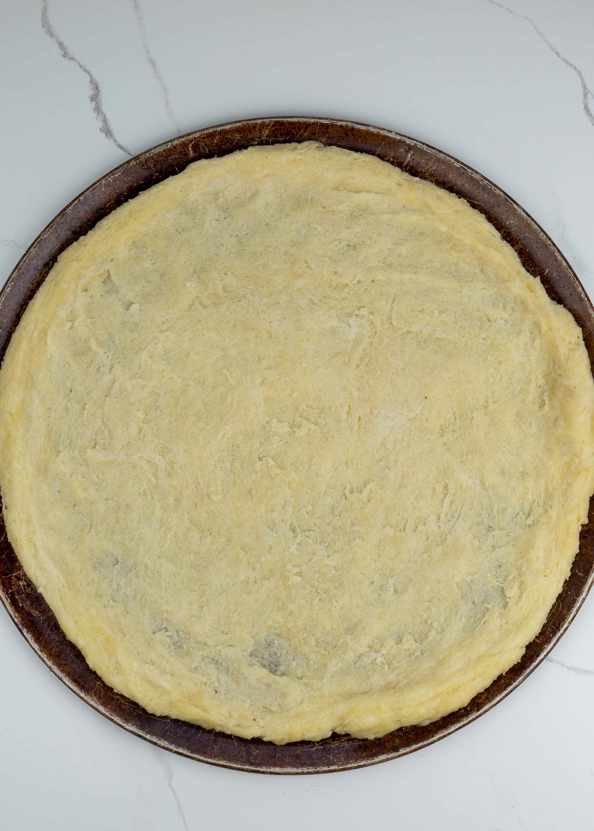 Follow this step by step guide to make the BEST Keto Pizza Crust Recipe! This crust is made from a fat head dough base and is low carb, grain and gluten free!