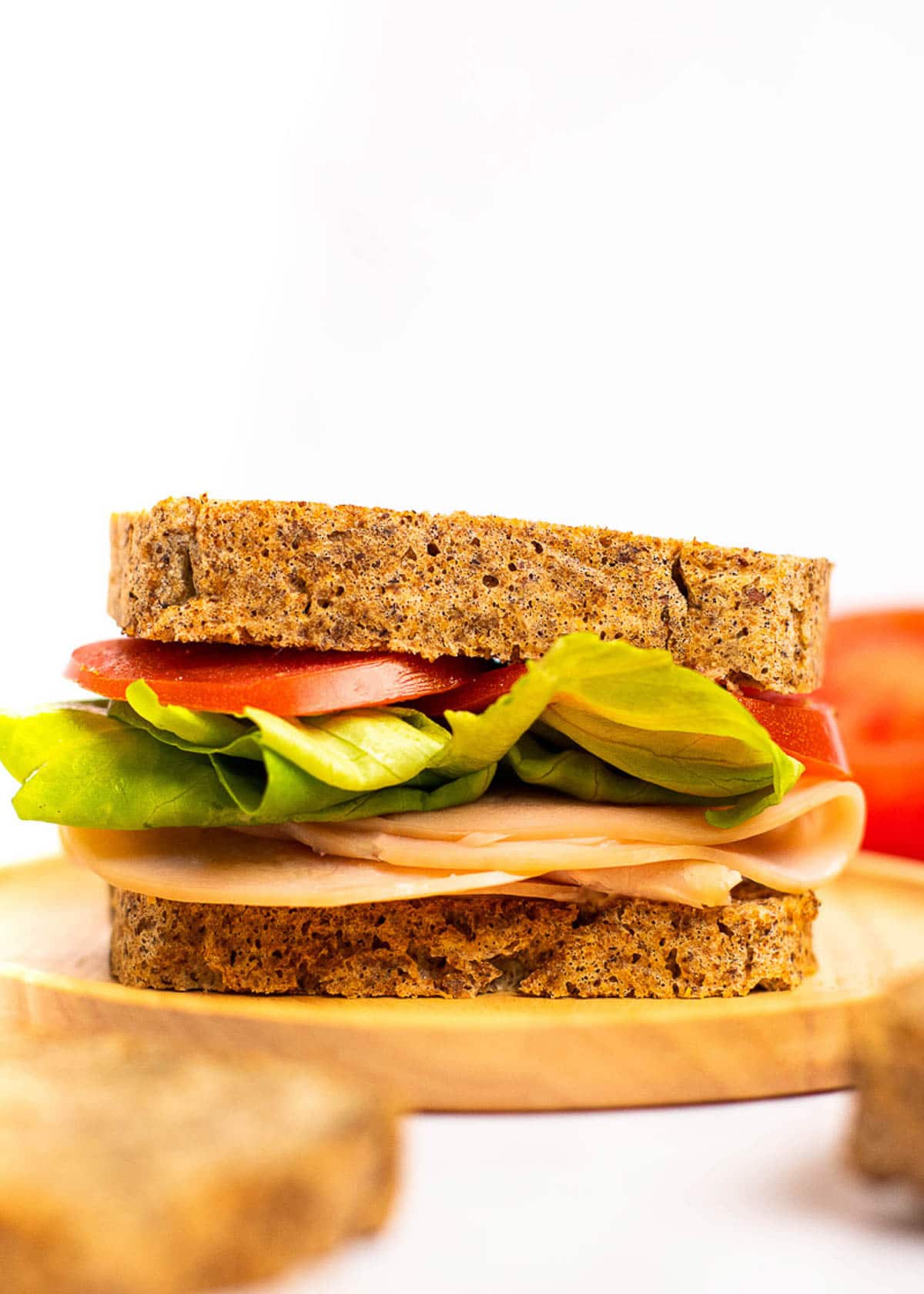 A turkey, lettuce, and tomato sandwich on a plate