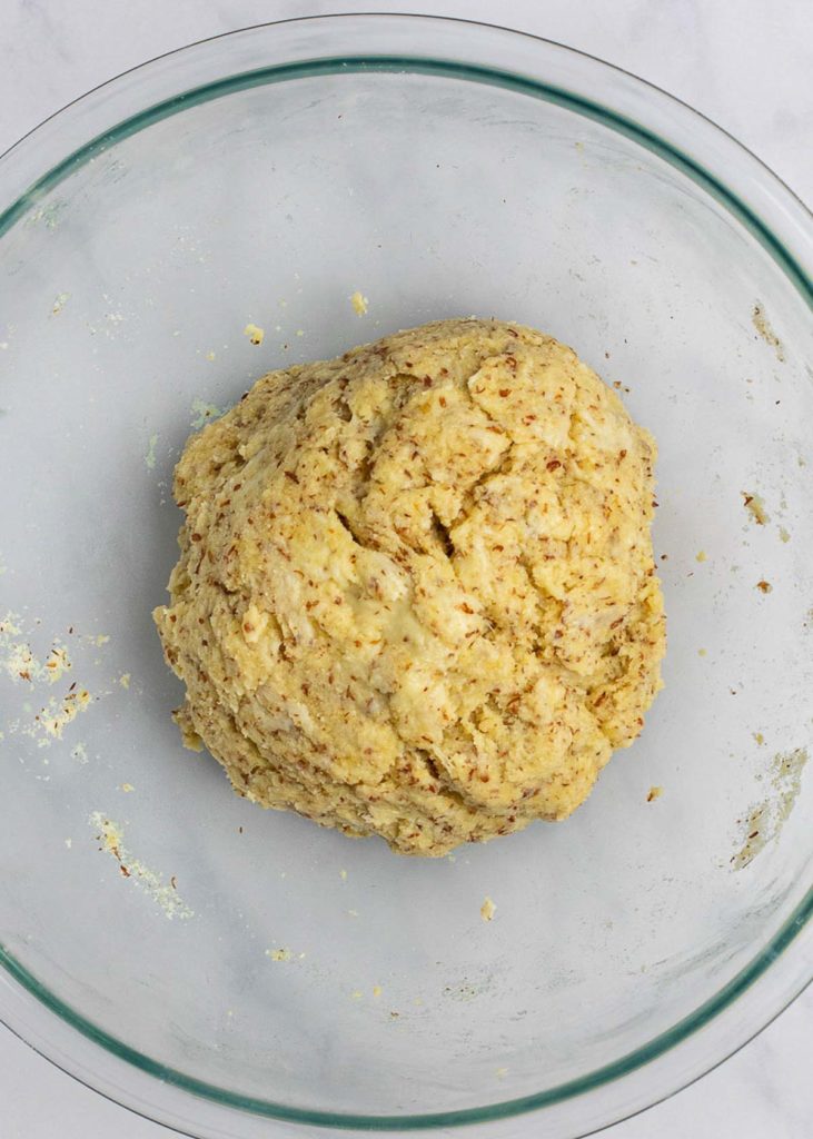 A mixing bowl with a ball of dinner roll dough