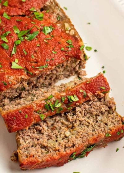 Overhead view of a log of meatloaf with two slices cut from it