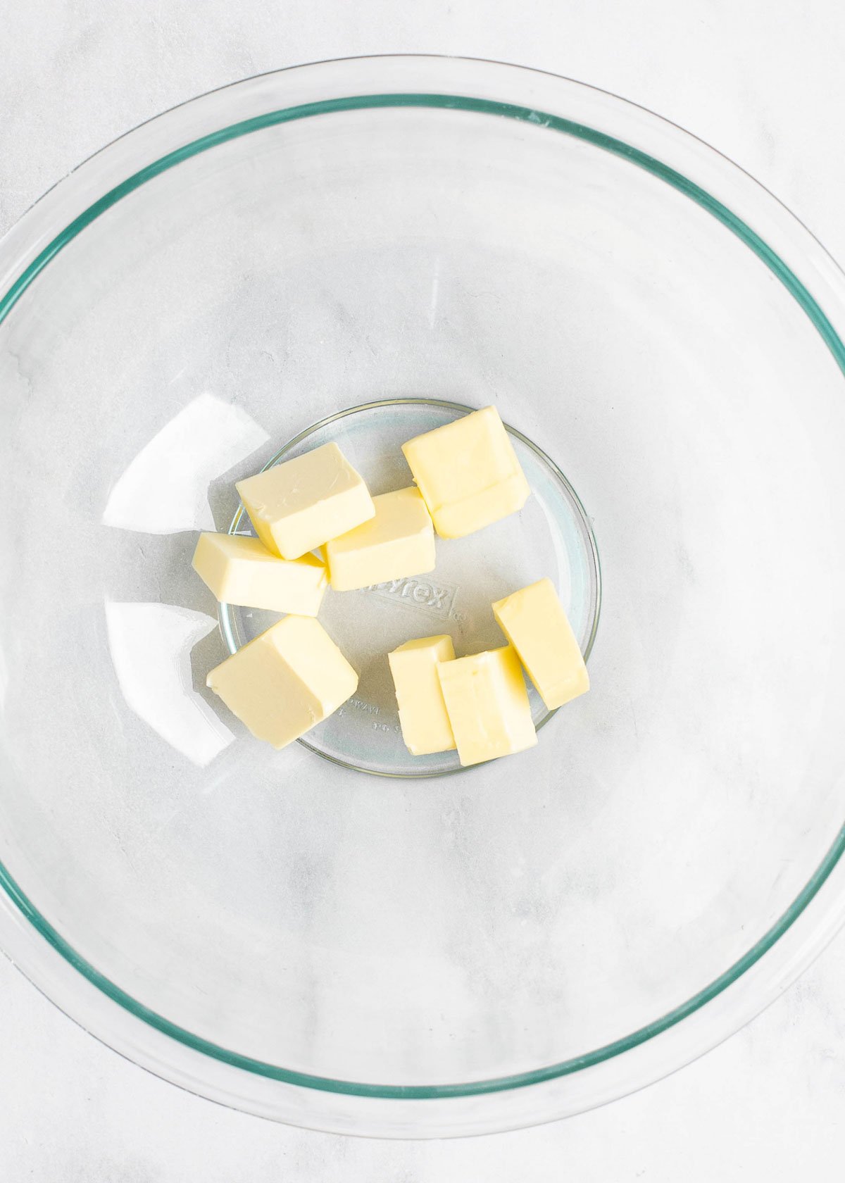 Overhead view of eight cubes of butter in a mixing bowl