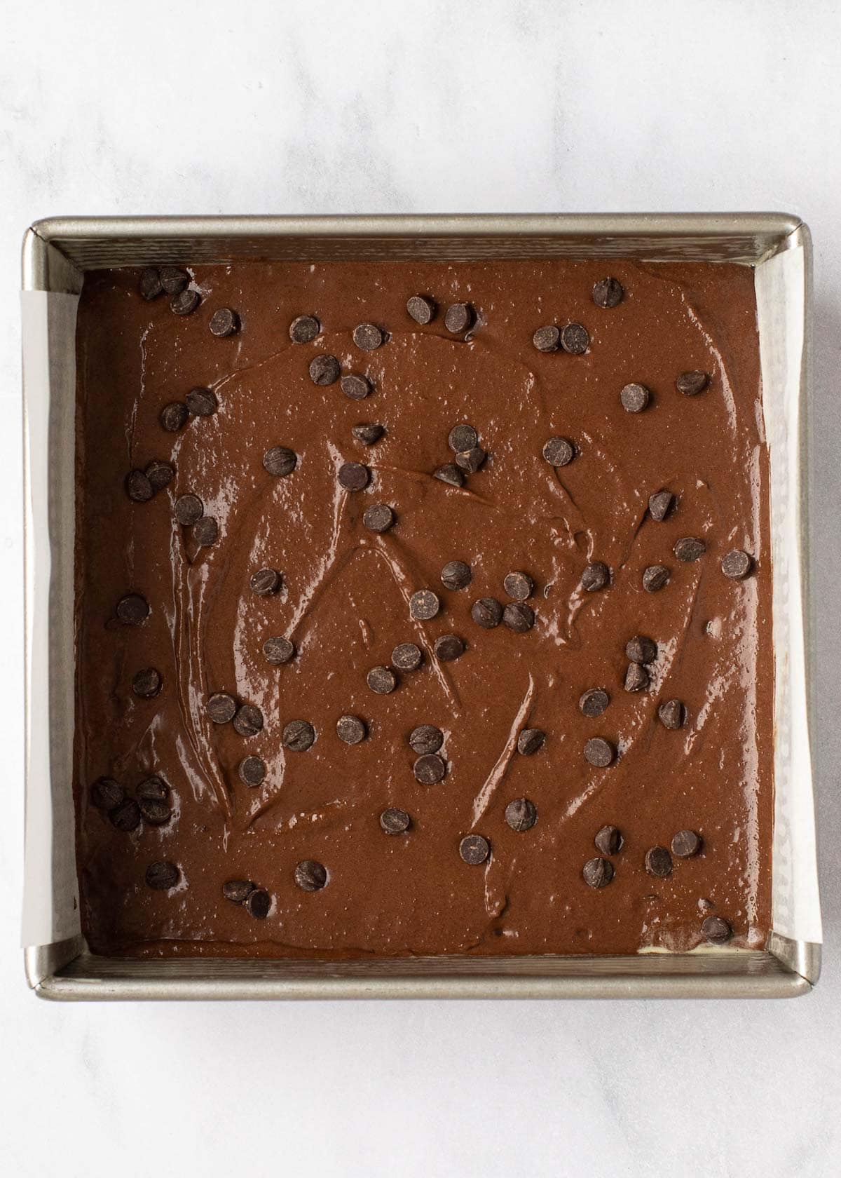 Overhead view of unbaked brownies in a pan