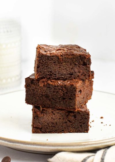 Three square brownies stacked on a plate