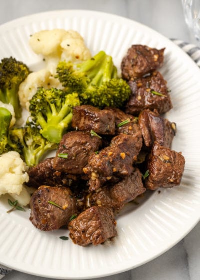 A plate full of steak bites, cauliflower, and broccoli