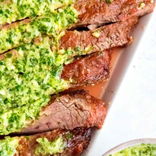 Juicy marinated Flank Steak is grilled to perfection and topped with zesty homemade Chimichurri sauce! This low-carb recipe is perfect for cookouts, parties, or a delicious weekend meal!