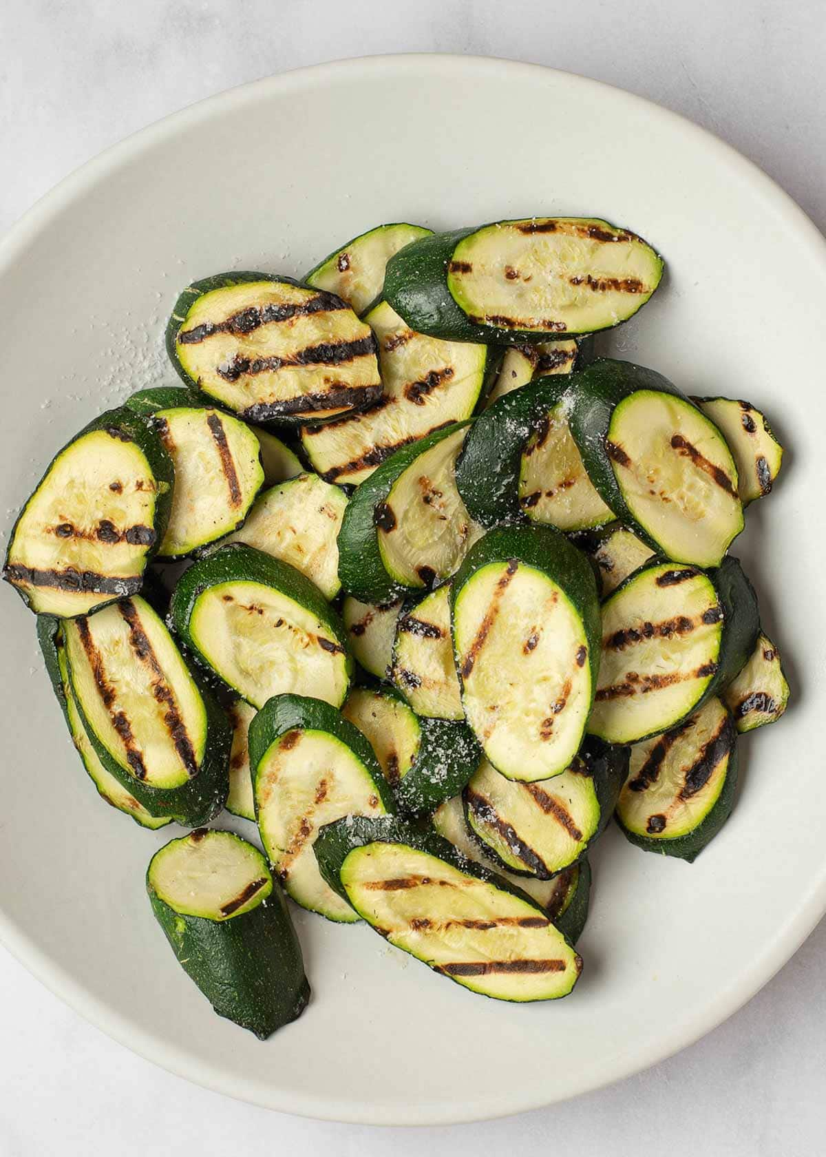This Grilled Zucchini Salad with a homemade red wine vinaigrette will be your repeat meal of the summer! This healthy recipe is ready in under 30 minutes, loaded with fresh mozzarella and tender veggies, and has fewer than 5 net carbs.