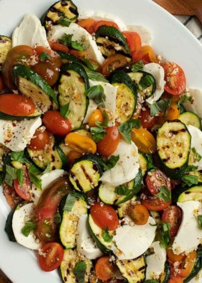 This Grilled Zucchini Salad with a homemade red wine vinaigrette will be your repeat meal of the summer! This healthy recipe is ready in under 30 minutes, loaded with fresh mozzarella and tender veggies, and has fewer than 8 net carbs.