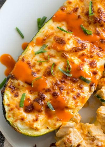 Try these Keto Buffalo Chicken Zucchini Boats packed with tangy buffalo sauce, chicken and cheese! These zucchini boats are cooked in either an air fryer or oven for a delicious low carb meal!