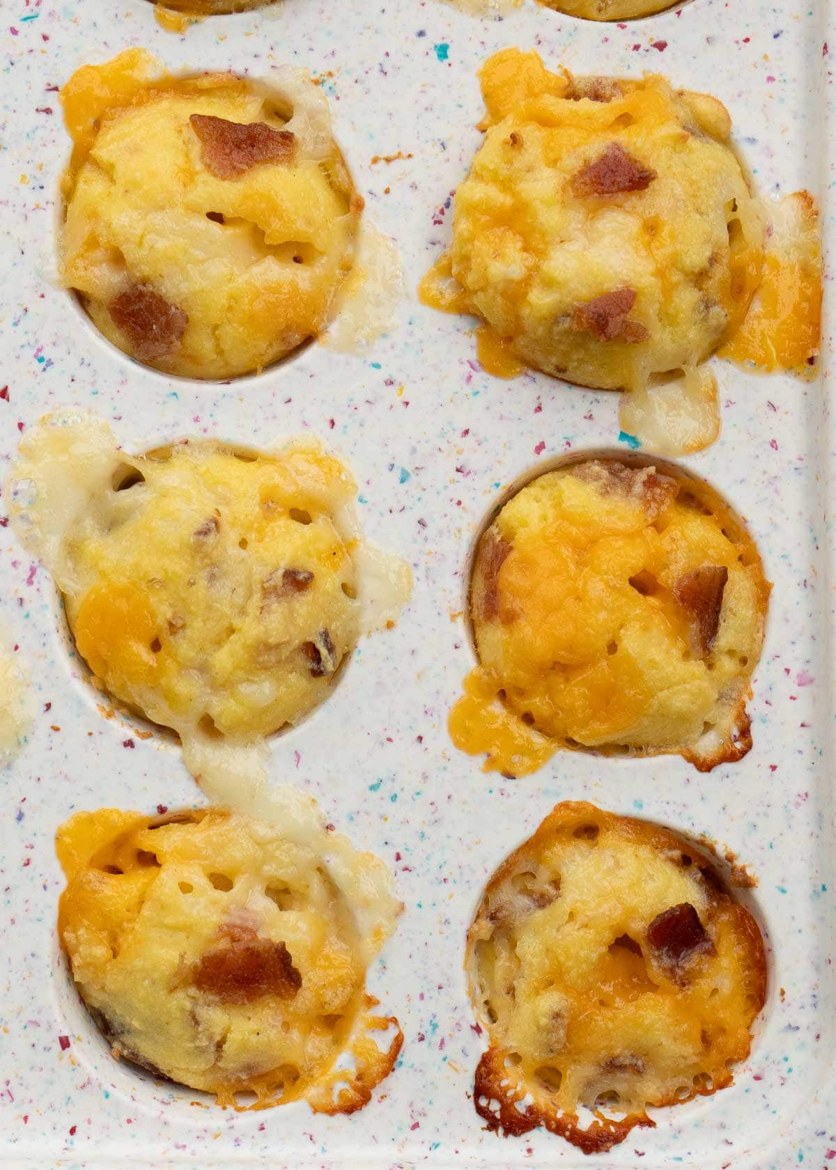 cooked bacon egg and cheese muffins in a muffin pan