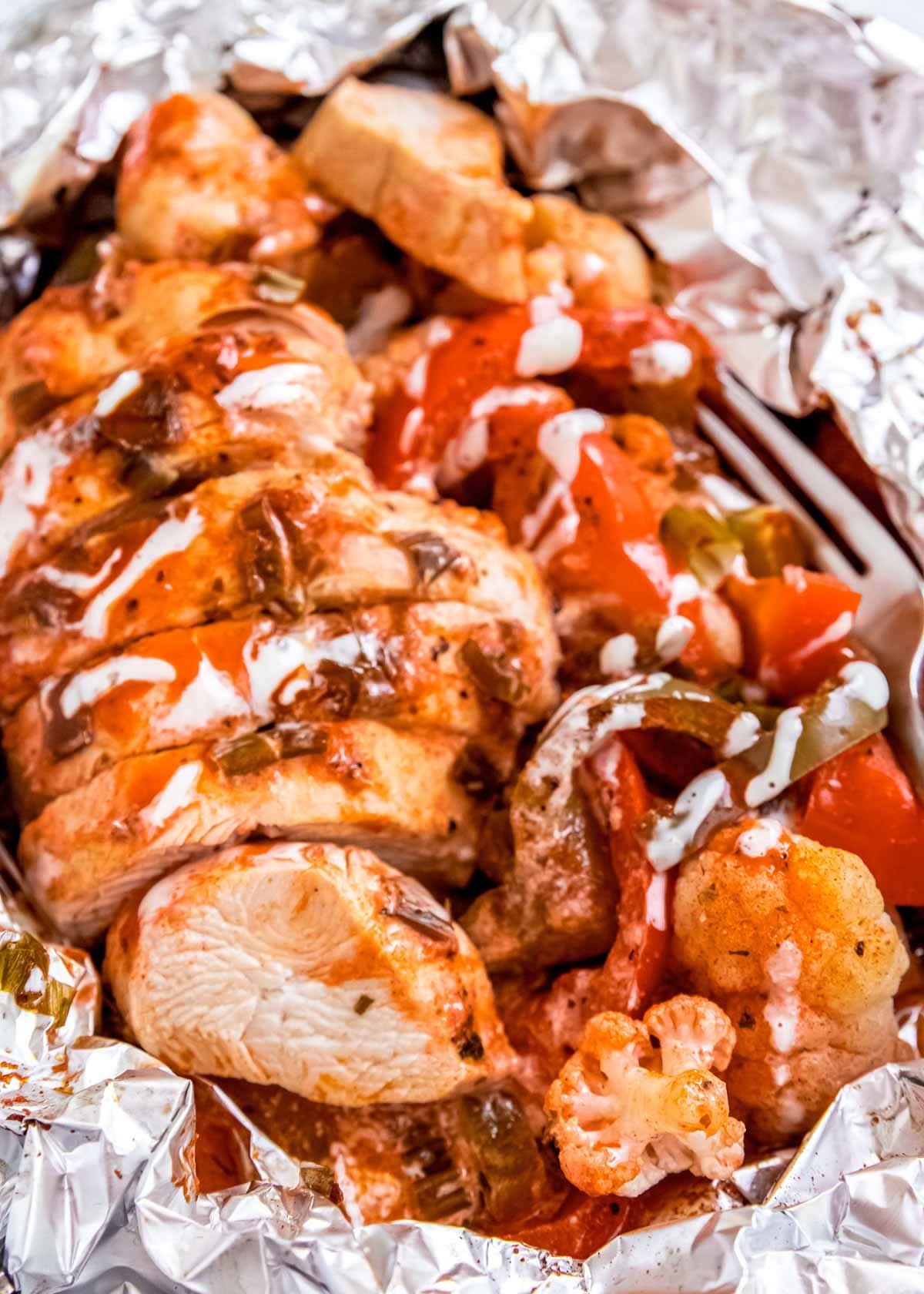 cooked and sliced buffalo chicken in foil pack