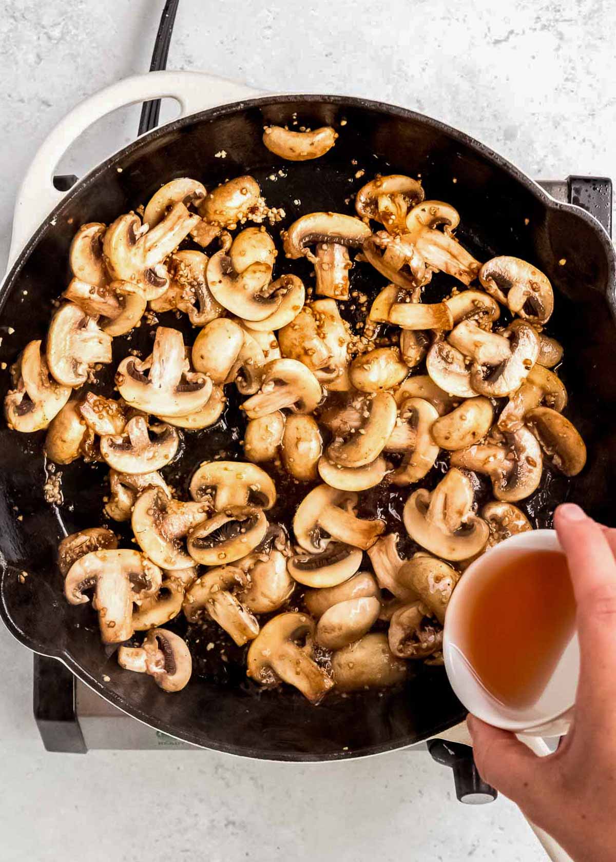 sauted mushrooms in pan with wine