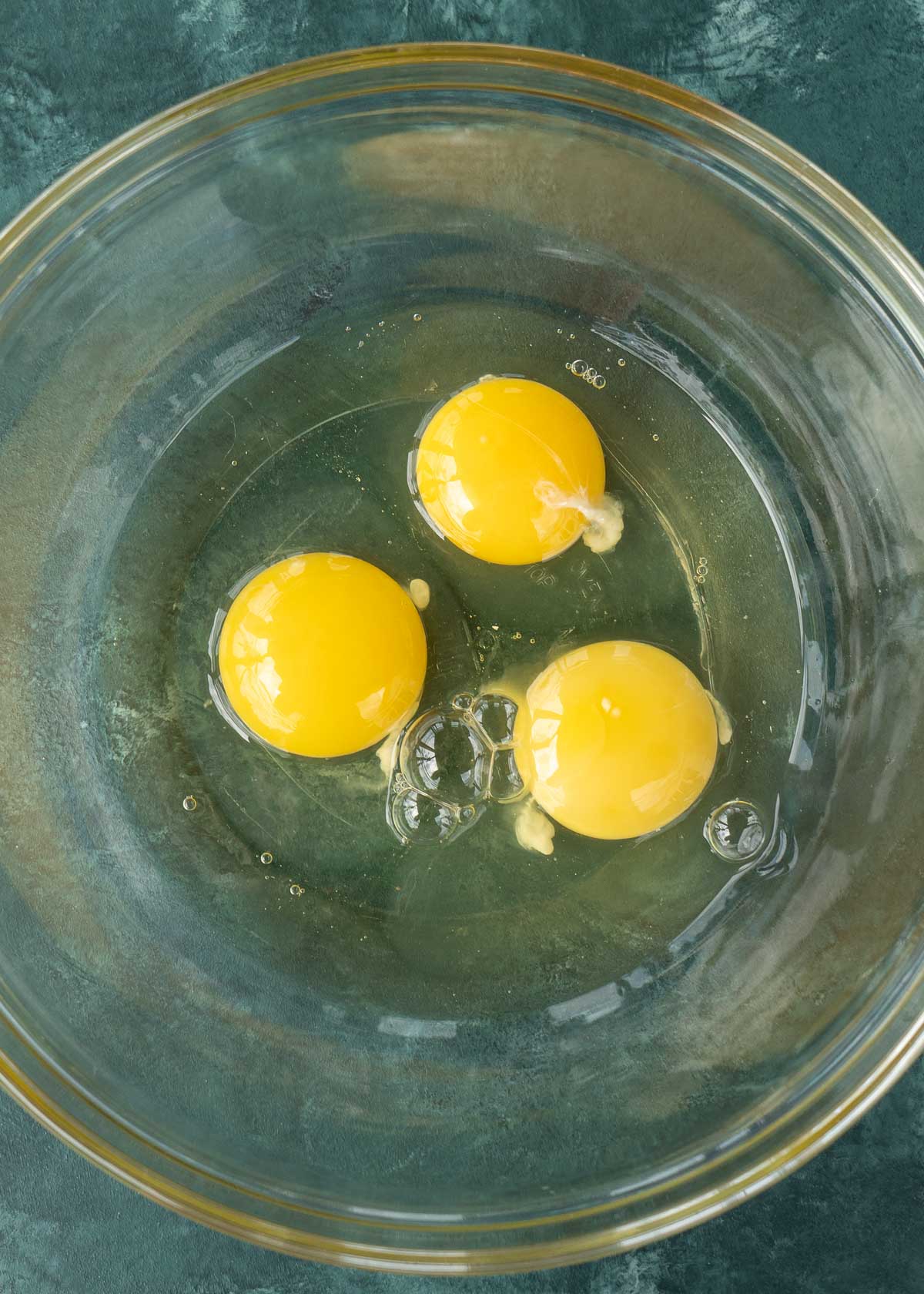 3 eggs in a glass bowl