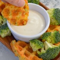 broccoli cheddar chaffle being dipped in dressing