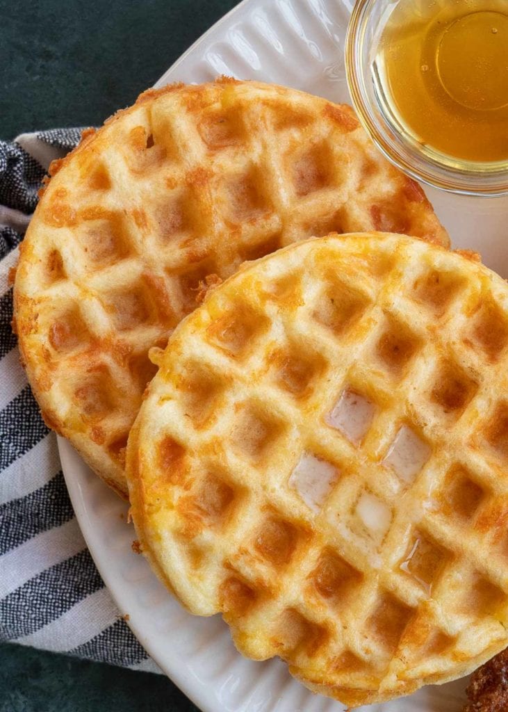 coconut flour chaffles with butter and syrup on a white plate