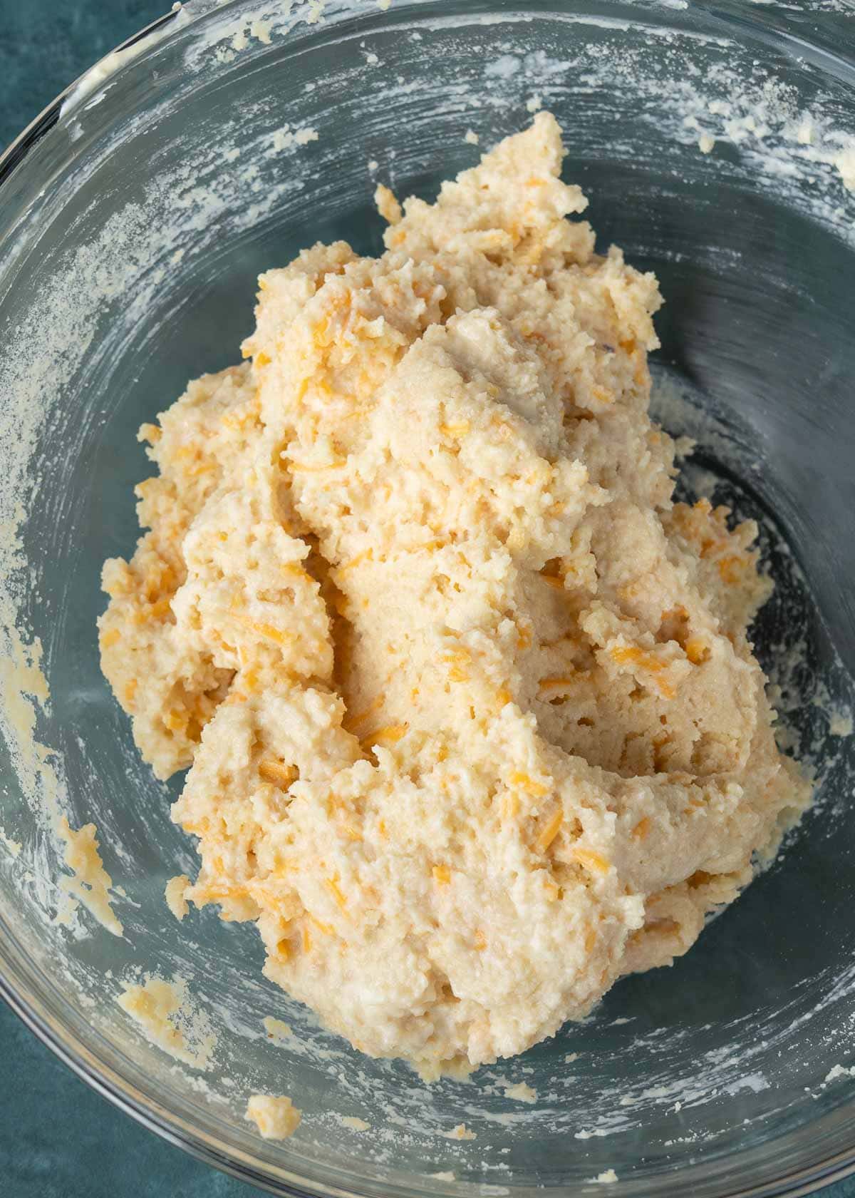 biscuit dough in a clear mixing bowl