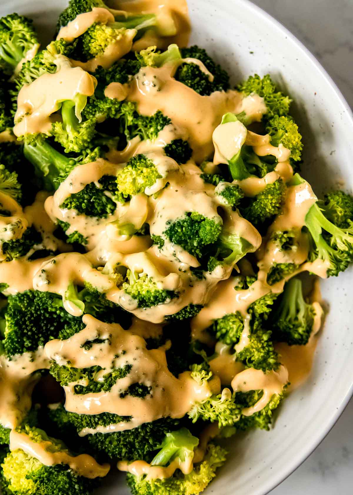 steamed broccoli covered with keto cheese sauce