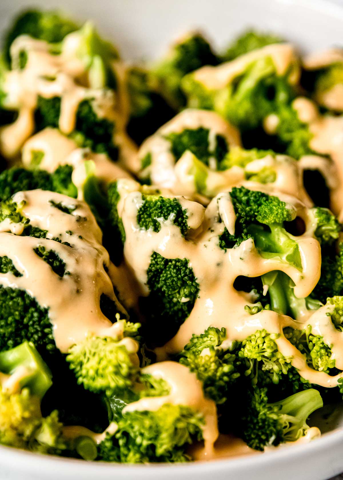 closeup of broccoli and cheese sauce in a bowl