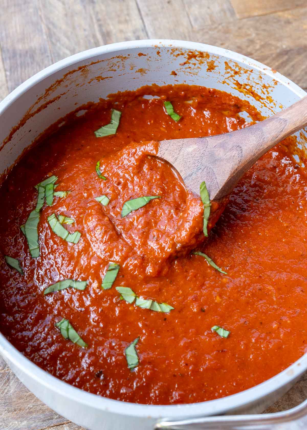 fresh tomato sauce in a pot with a wooden spoon